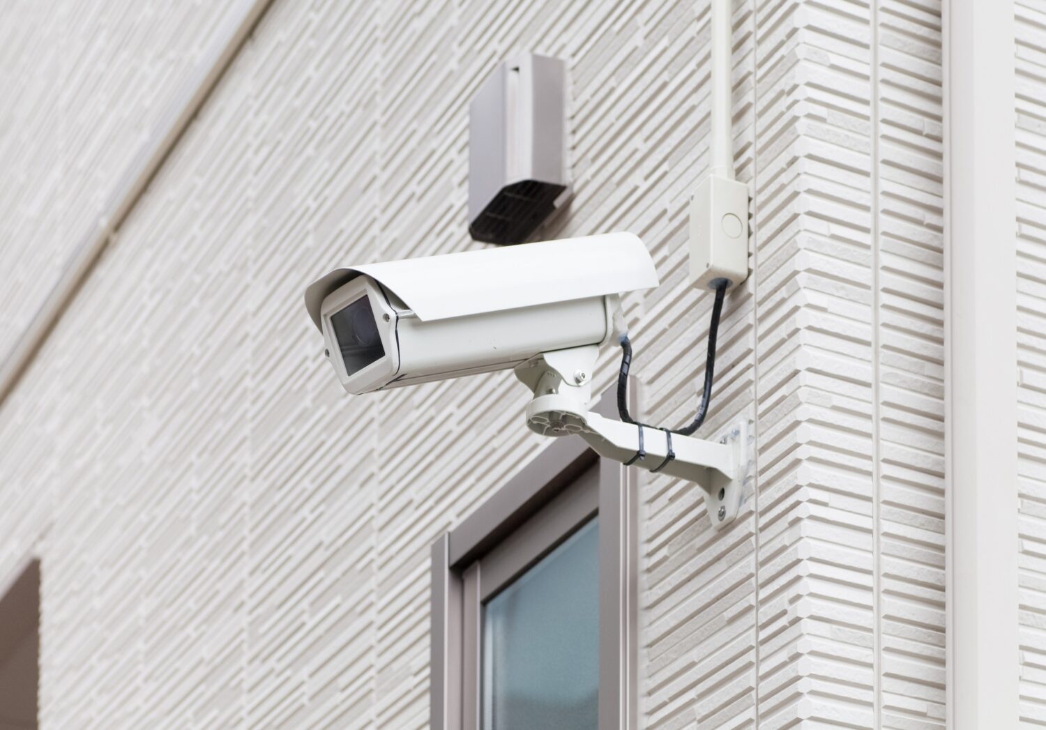 Security camera mounted on the side of a building
